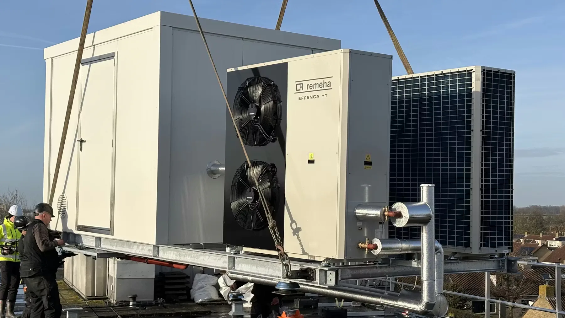 Op een dak van een flat wordt een hogetemperatuurwarmtepomp geplaatst. Foto: Energy Bridge